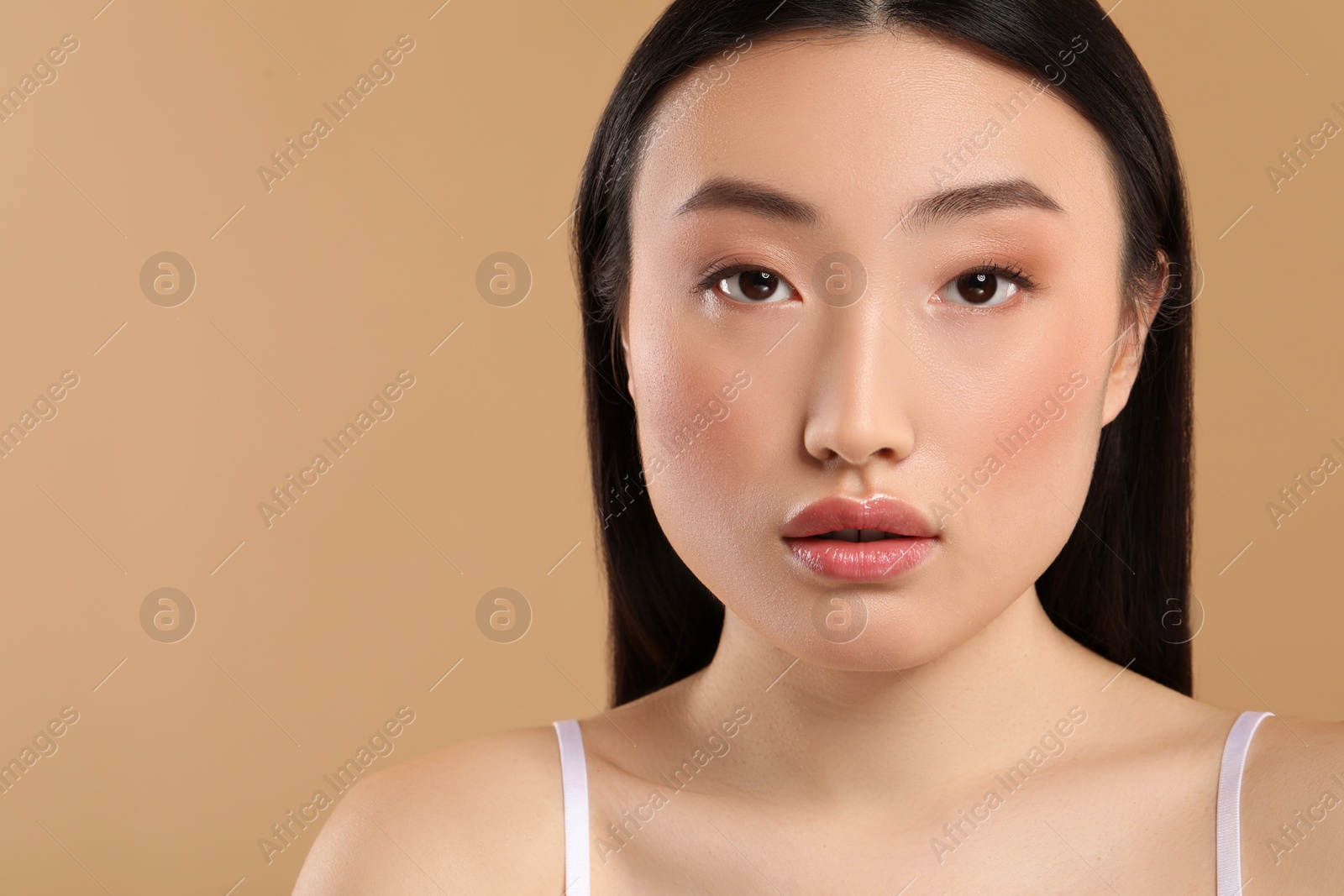 Photo of Beautiful woman with healthy skin on beige background, space for text