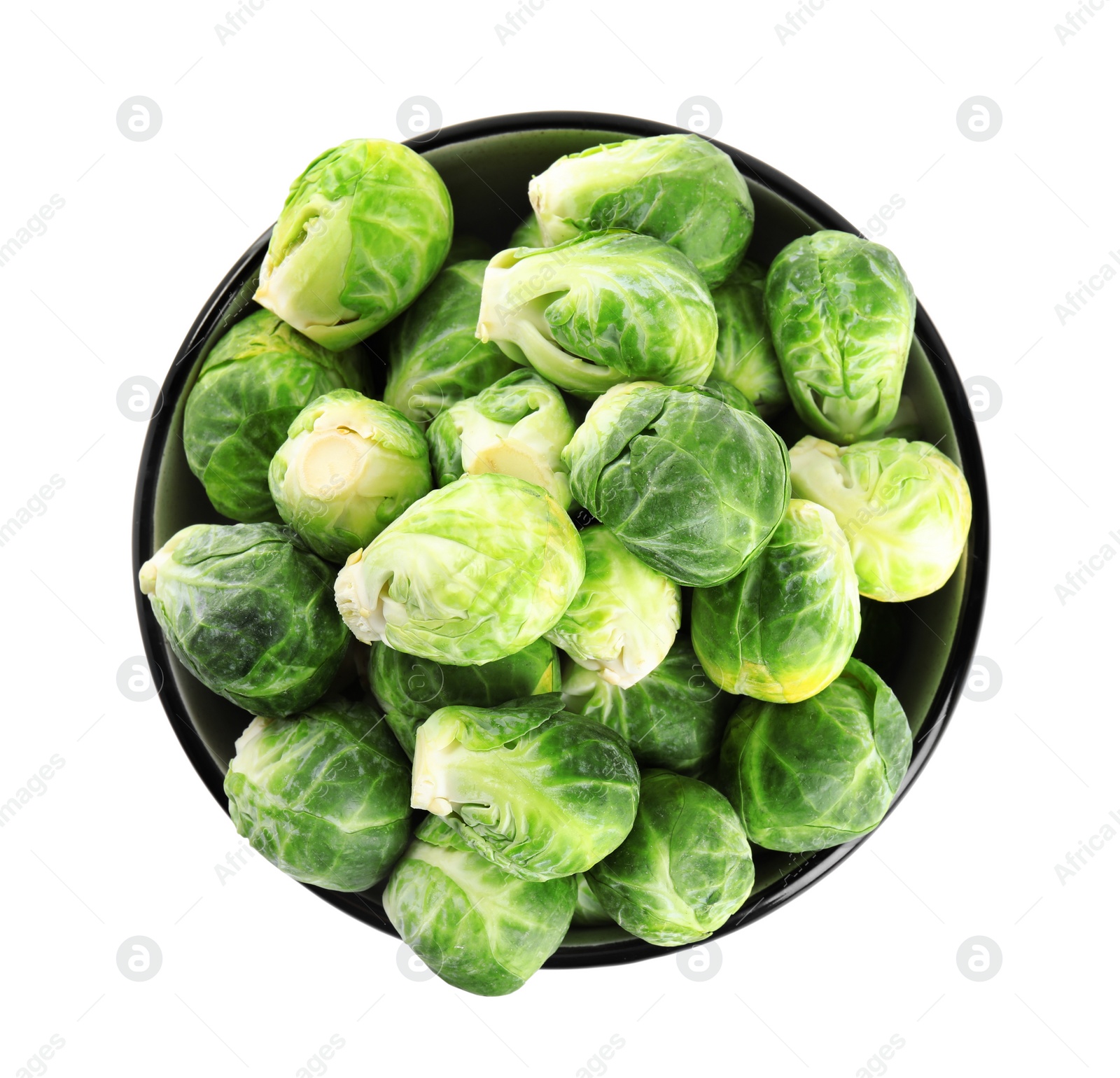 Photo of Fresh Brussels sprouts in bowl isolated on white, top view