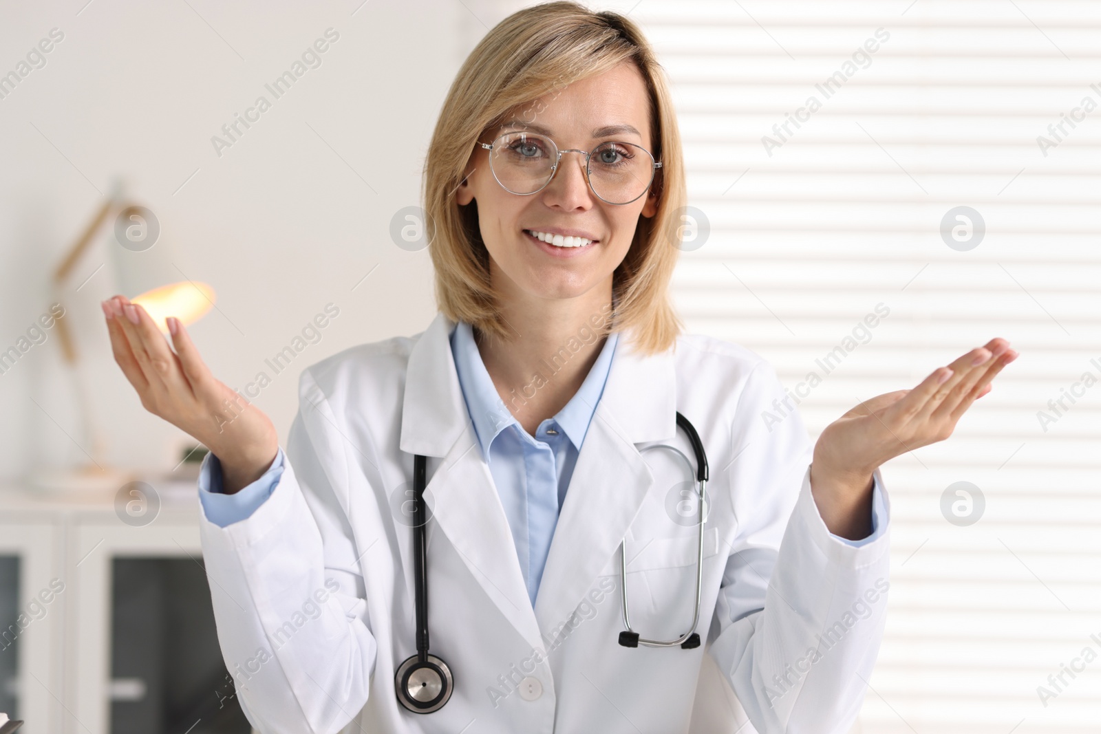 Photo of Portrait of smiling doctor on blurred background