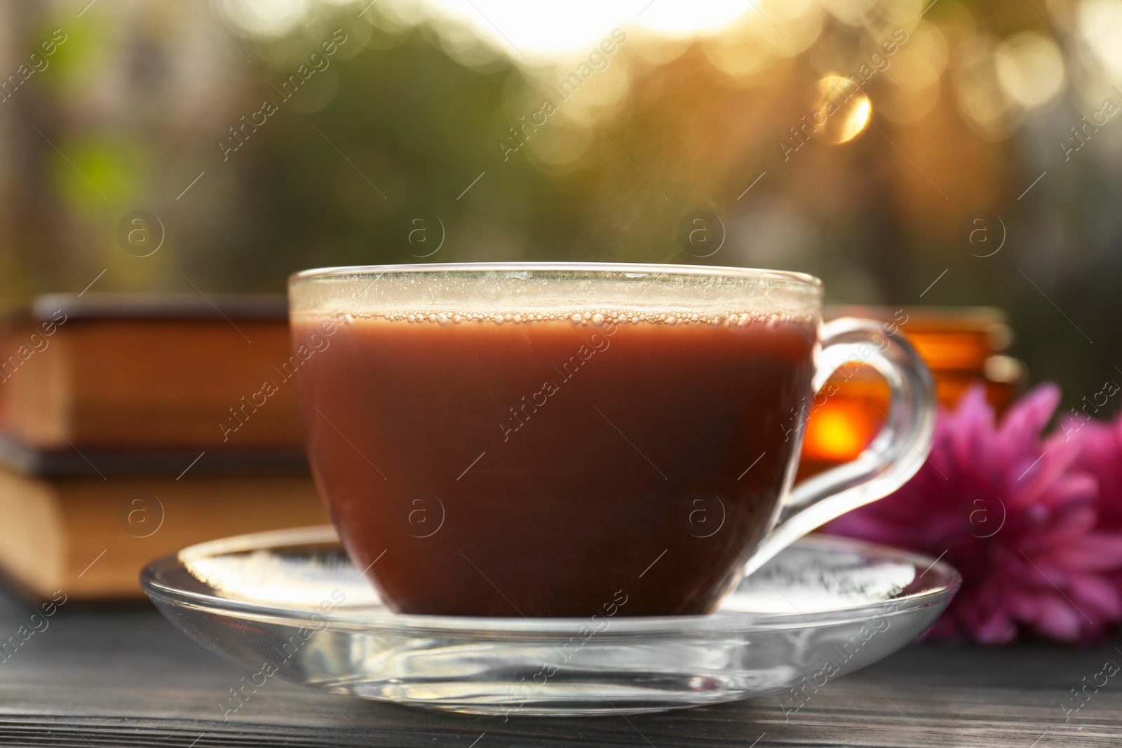 Photo of Glass cup with coffee on wooden table, closeup. Morning ritual