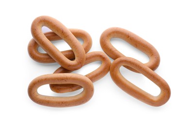 Photo of Many tasty dry bagels (sushki) isolated on white, top view