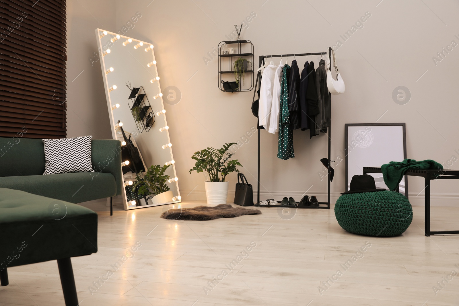 Photo of Modern dressing room interior with clothing rack and mirror