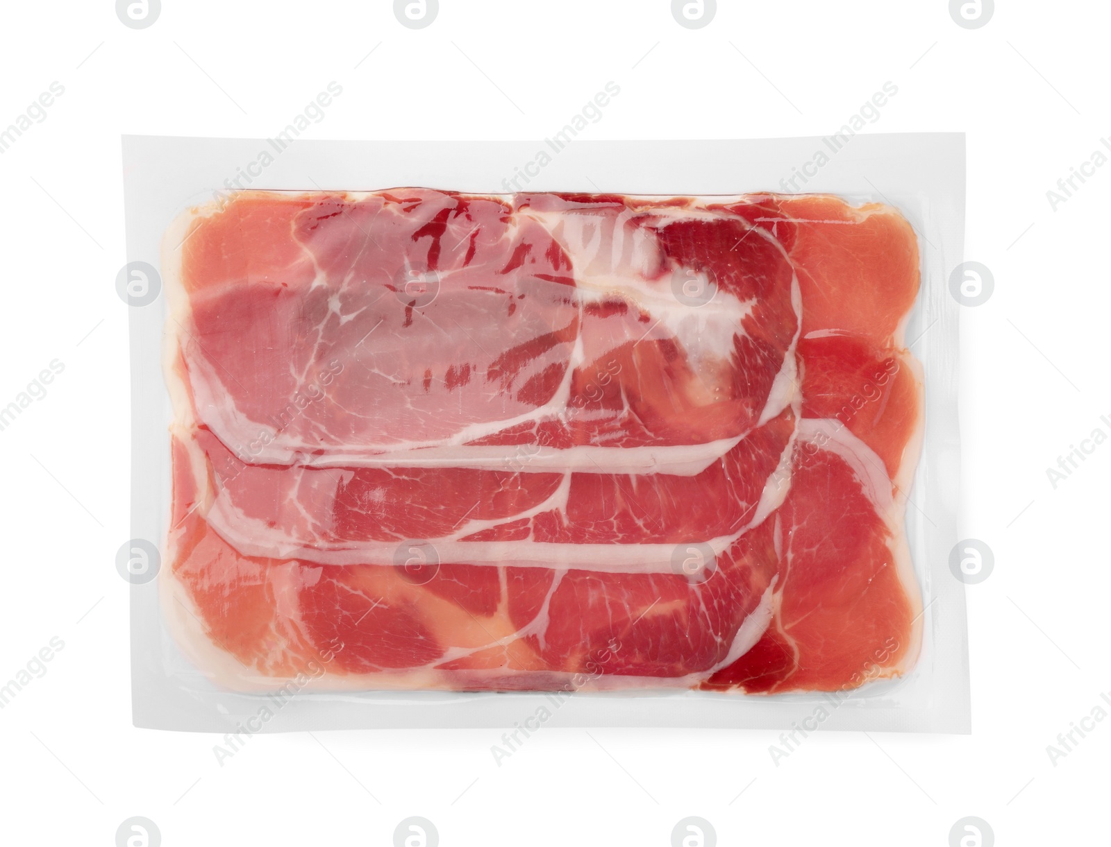 Photo of Pack of delicious sliced jamon isolated on white, top view