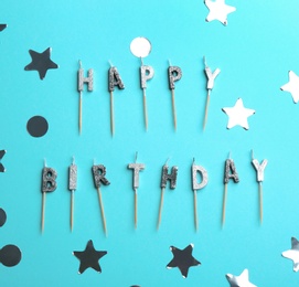 Flat lay composition with birthday candles on color background