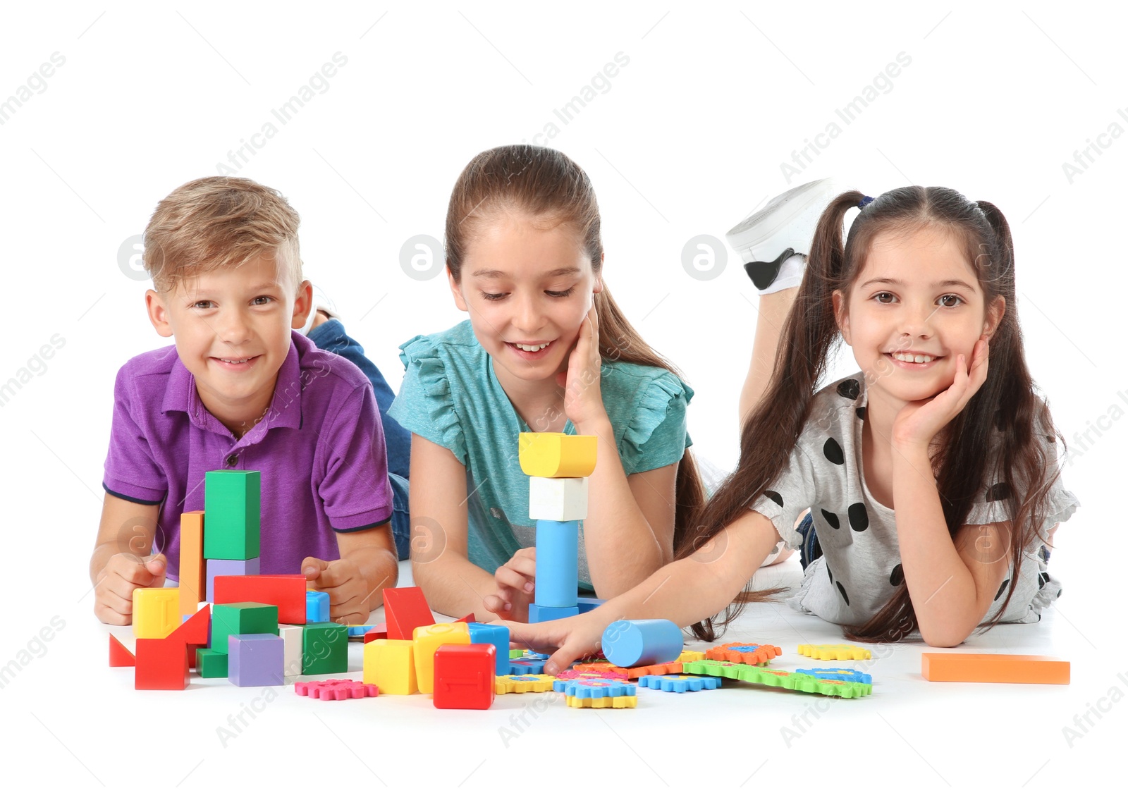 Photo of Little children playing together on white background. Indoor entertainment