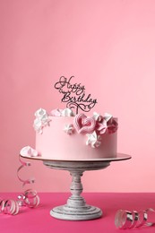 Photo of Beautifully decorated birthday cake on pink background