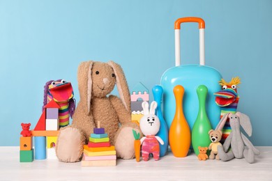 Collection of different toys on white wooden table