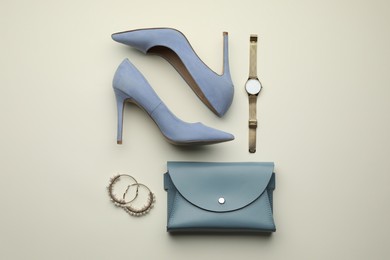 Photo of Stylish woman's bag, shoes and accessories on light background, flat lay