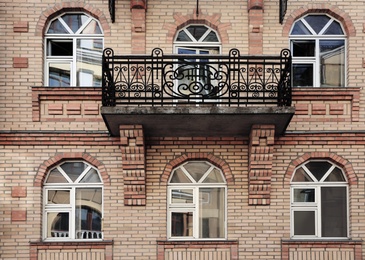 Wall of brick building with stylish windows