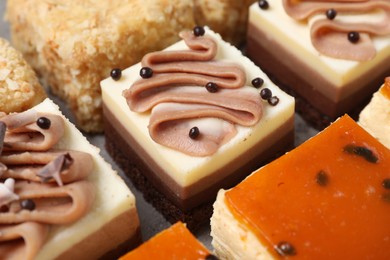 Photo of Pieces of different delicious cakes on table, closeup