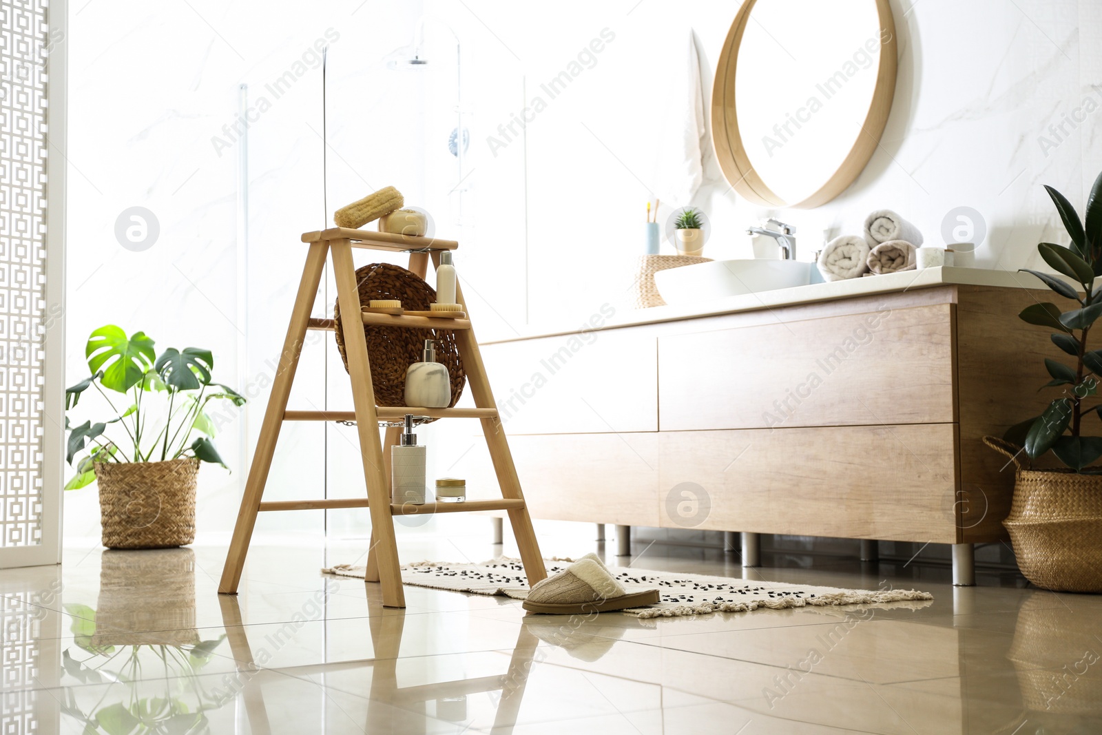 Photo of Dispensers and different toiletries on decorative ladder in bathroom. Idea for interior design