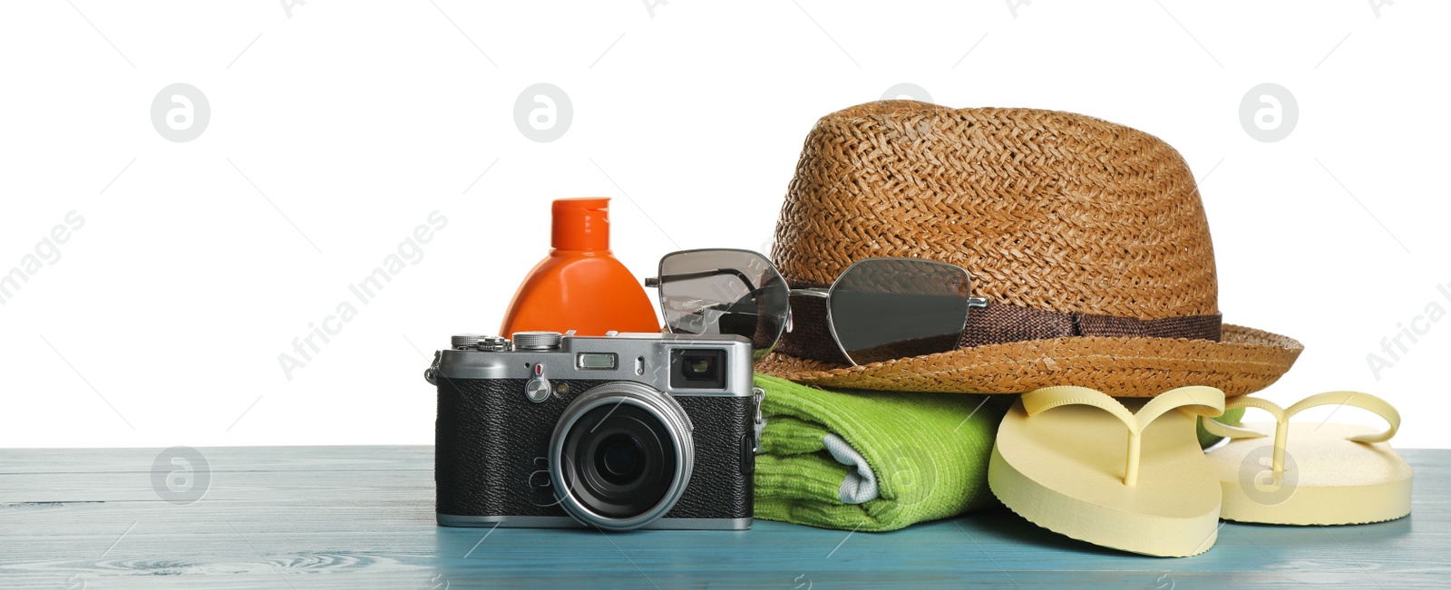 Photo of Different beach objects on turquoise wooden table against white background