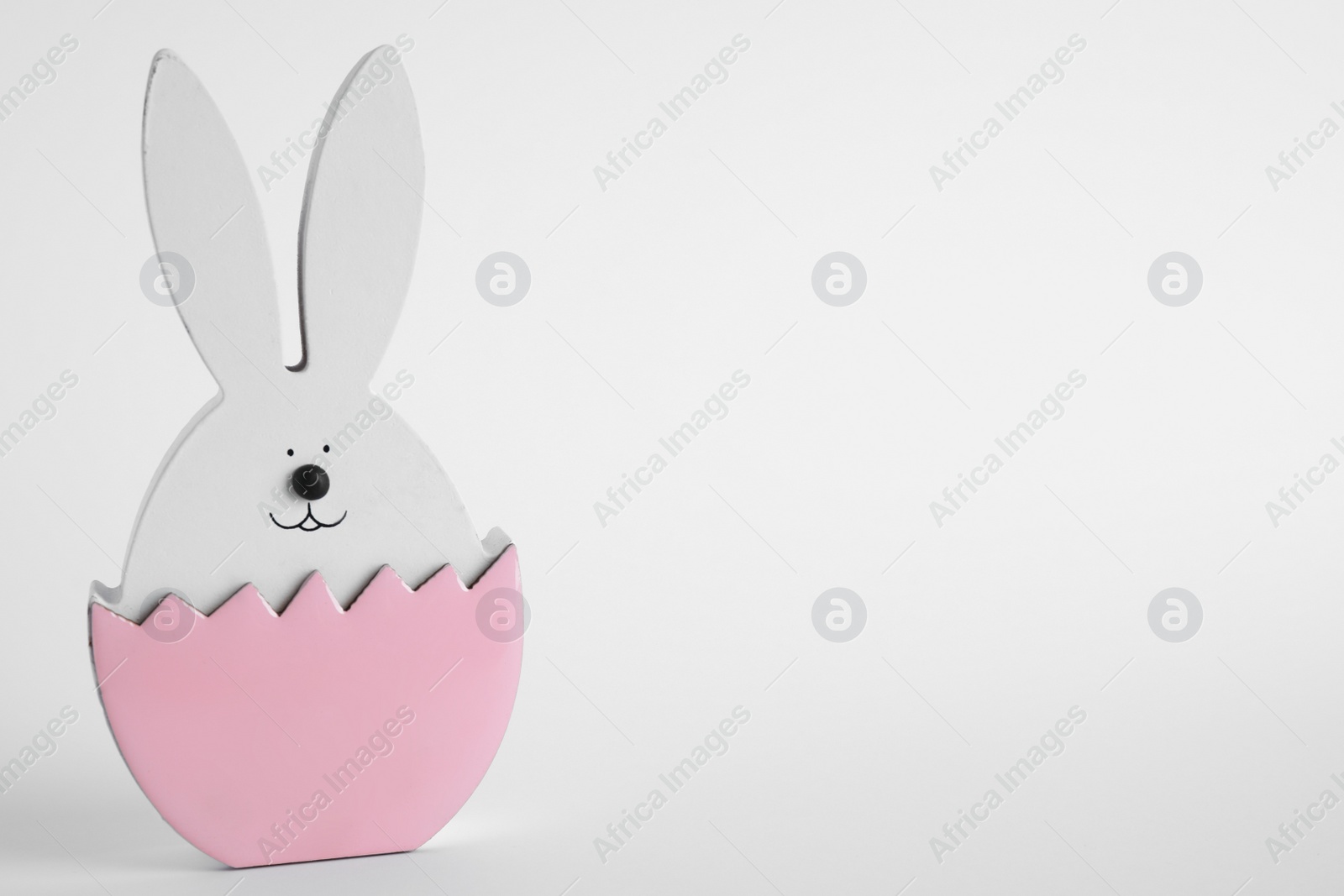 Photo of Easter bunny figure on white background. Space for text