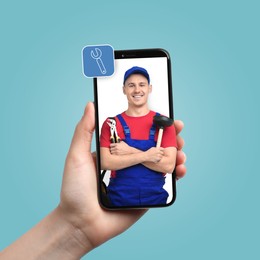 Find plumber. Man using mobile phone on light blue background, closeup. Specialist looking out of gadget