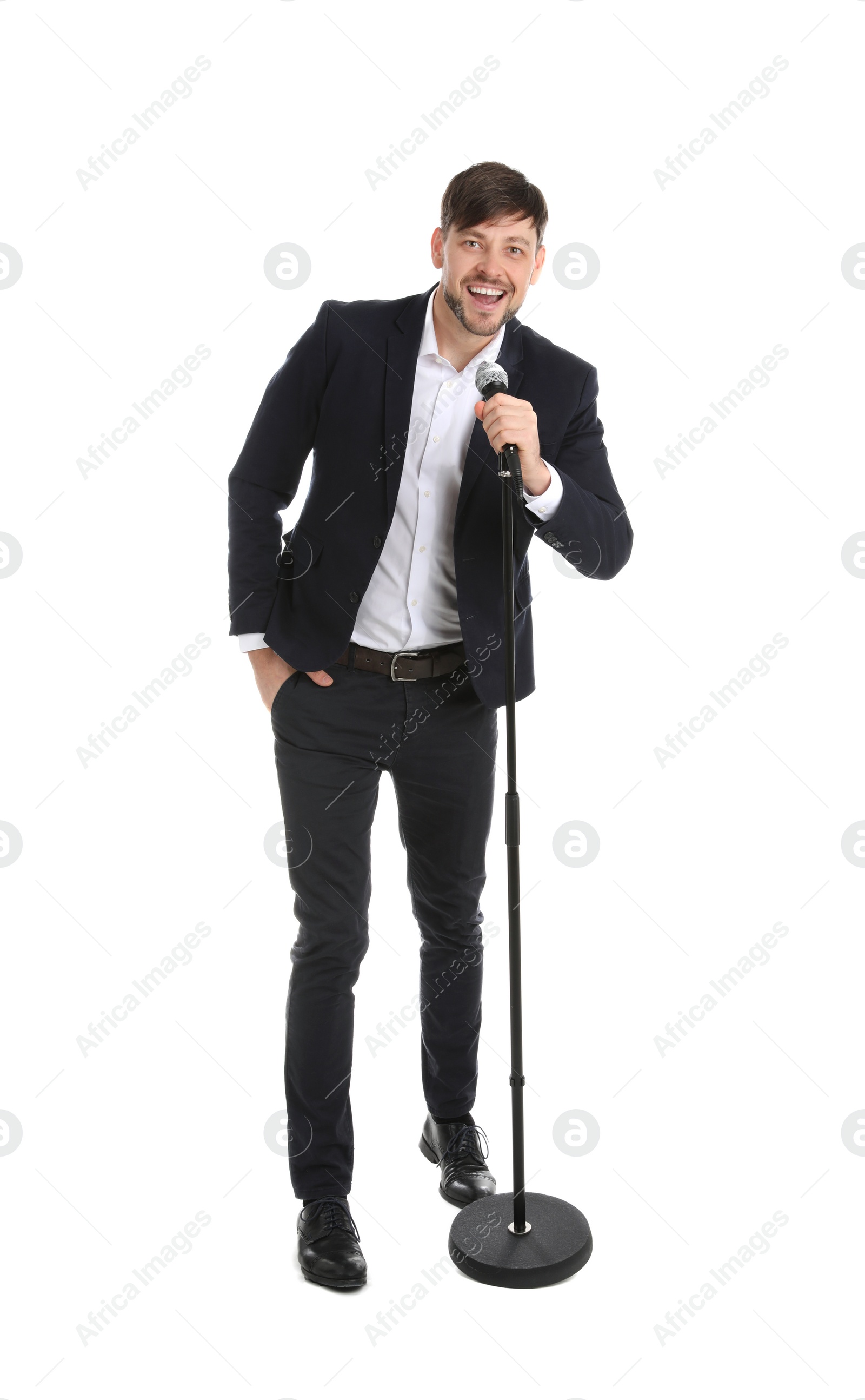 Photo of Handsome man in suit singing with microphone on white background
