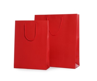 Photo of Red paper shopping bags isolated on white