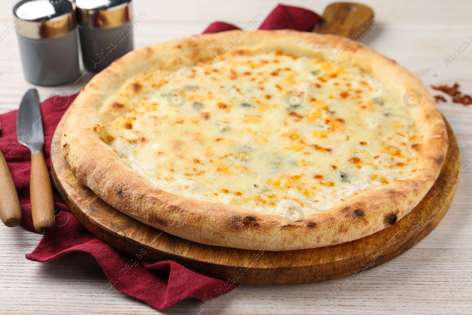 Photo of Delicious cheese pizza on white wooden table, closeup