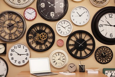 Photo of Collection of wall clocks over workplace indoors