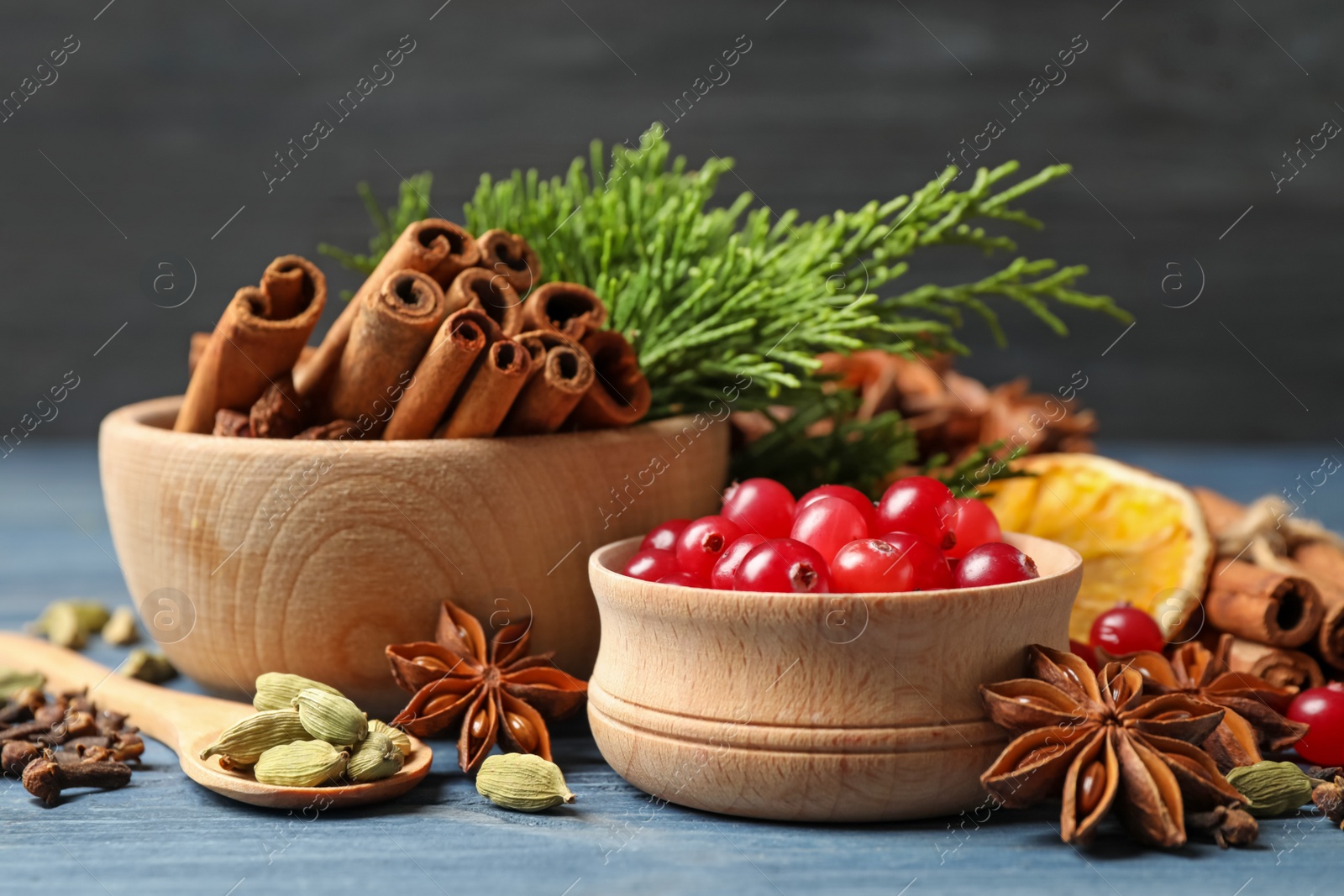 Photo of Composition with mulled wine ingredients on blue wooden table, closeup