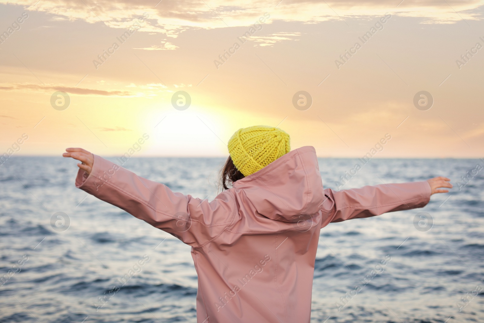 Photo of Stylish young woman spending time near sea