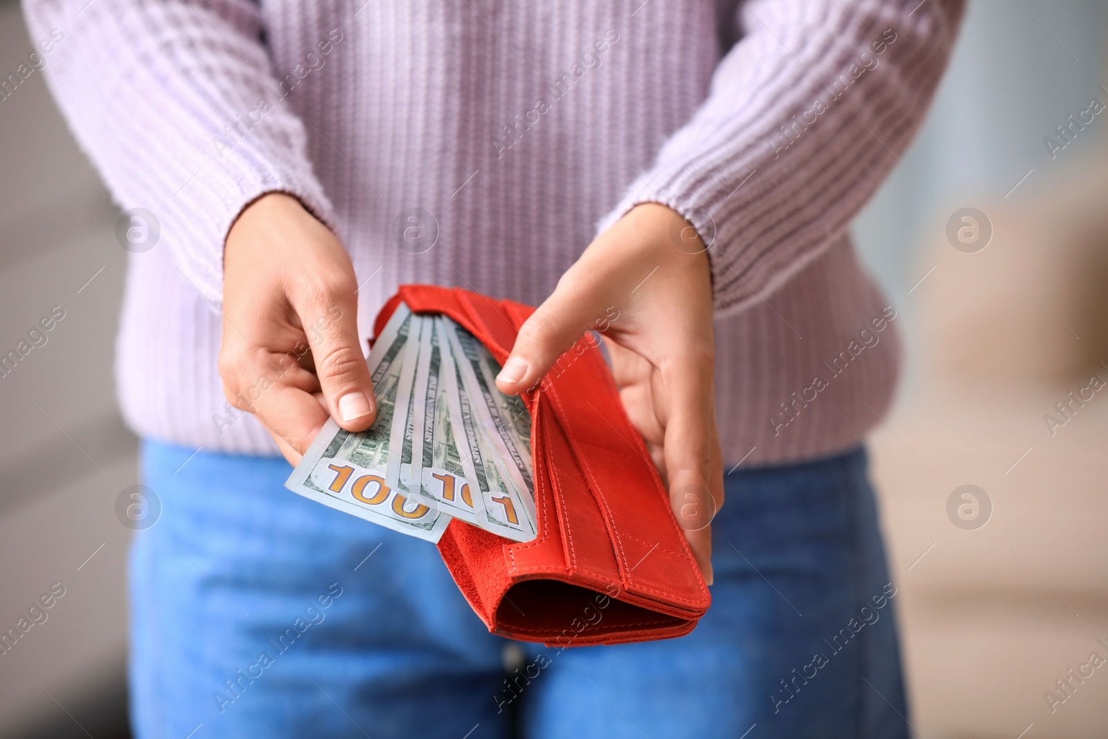 Photo of Woman with American money in wallet indoors, closeup