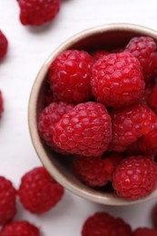 Photo of Tasty ripe raspberries on white table, top view