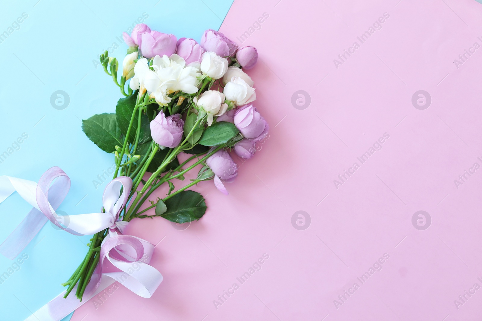 Photo of Bouquet of beautiful flowers on color background, top view