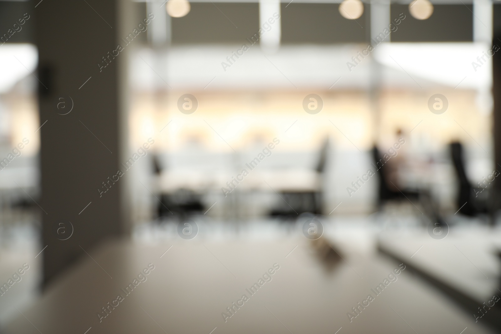 Photo of Blurred view of cozy workspaces with tables and chairs in office