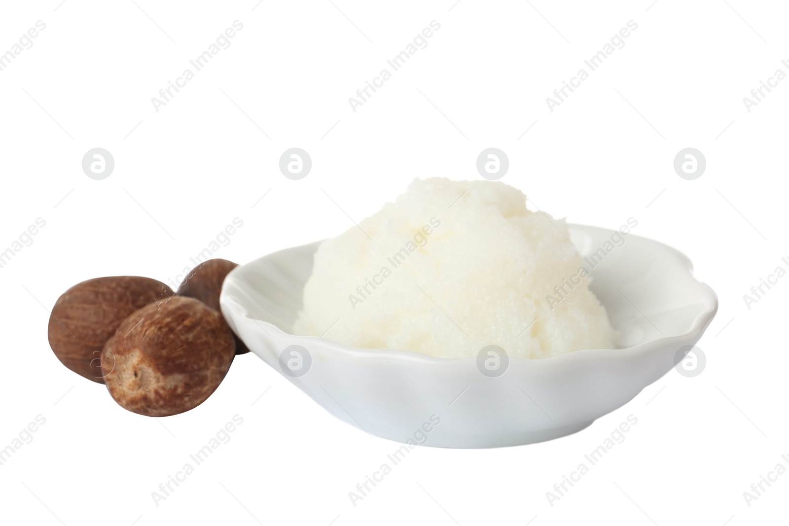 Photo of Shea butter in bowl and nuts isolated on white