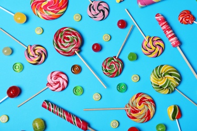 Photo of Flat lay composition with different tasty candies on color background