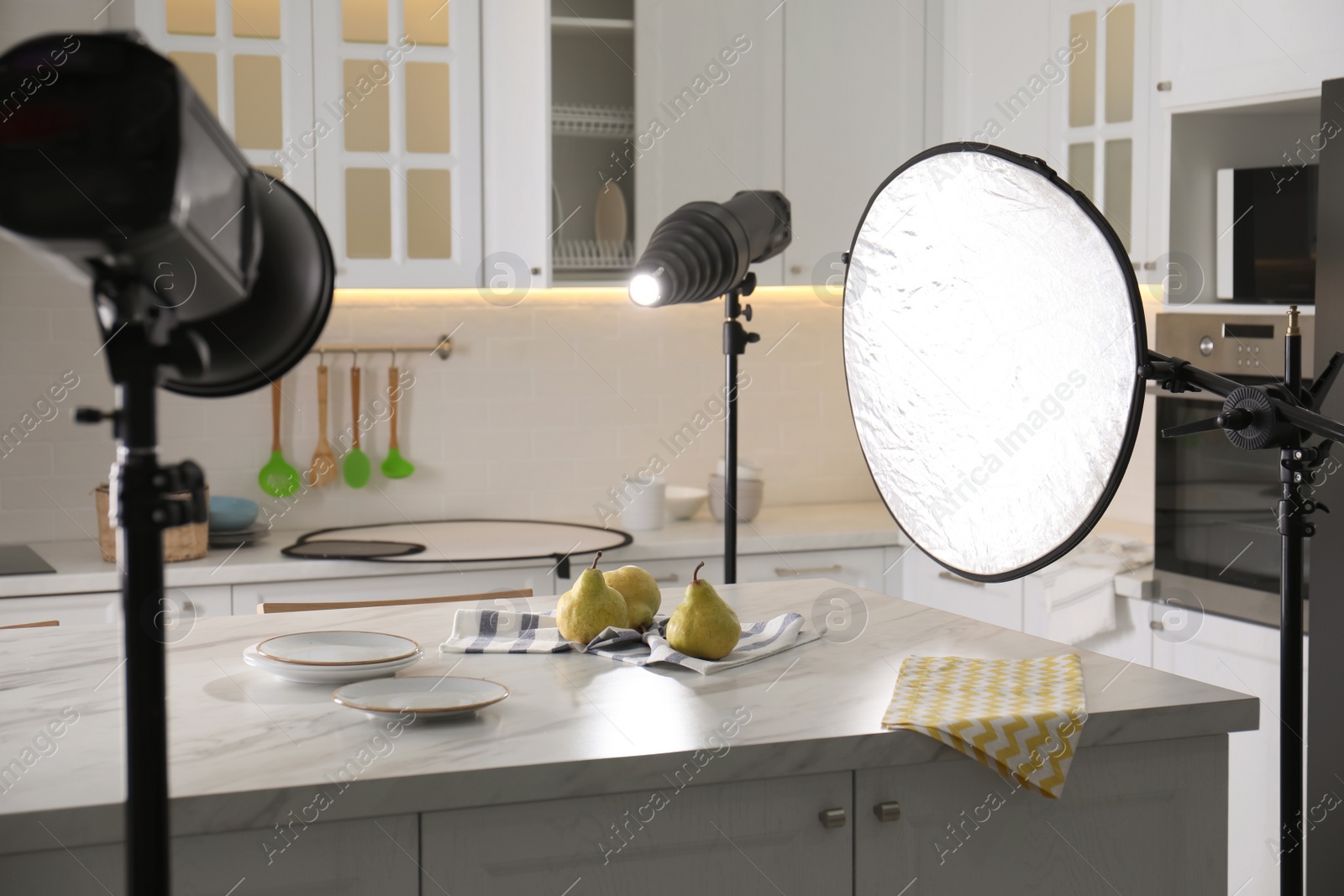 Photo of Professional equipment and many pears on table in kitchen. Food photo