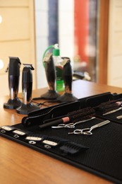 Photo of Stylish hairdresser's workplace with professional tools and cosmetic products in barbershop