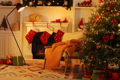 Photo of Living room interior with fireplace, armchair and Christmas decor
