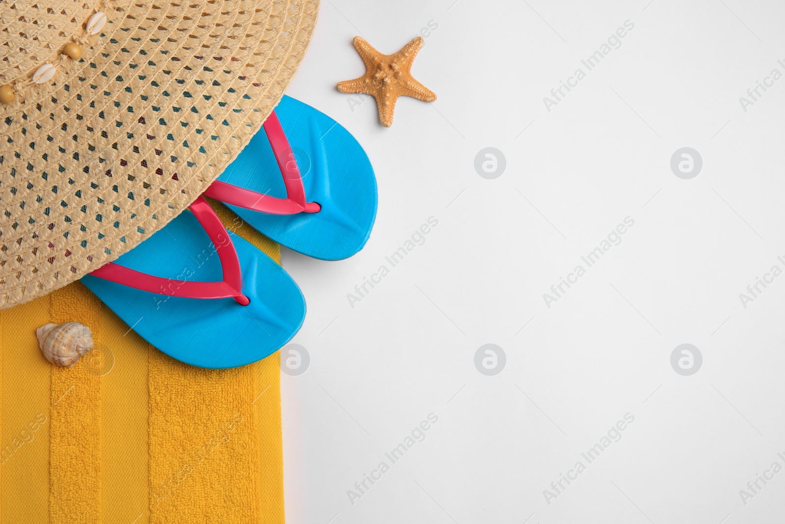 Photo of Flat lay composition with beach accessories on white background, space for text