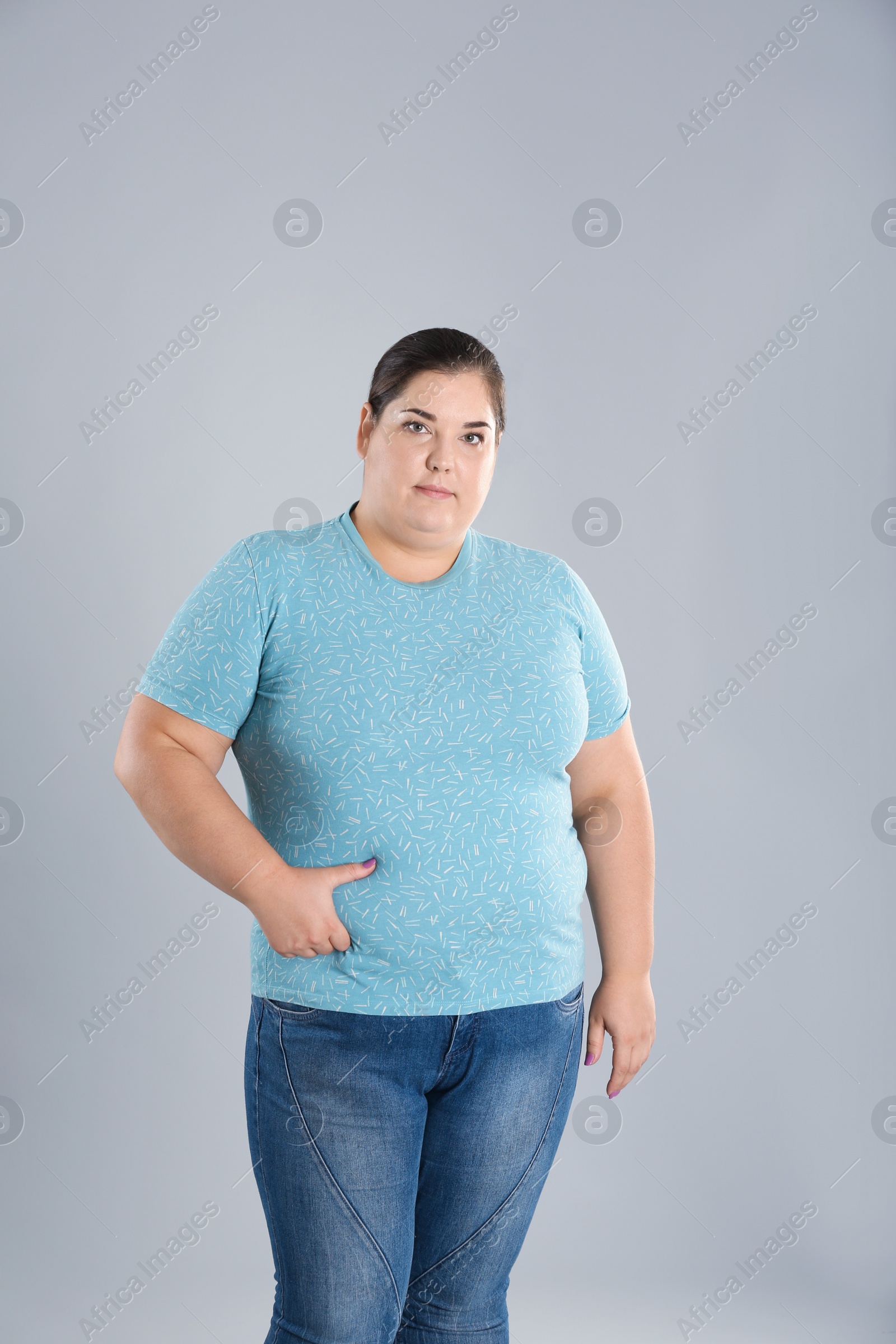 Photo of Overweight woman touching belly fat before weight loss on color background