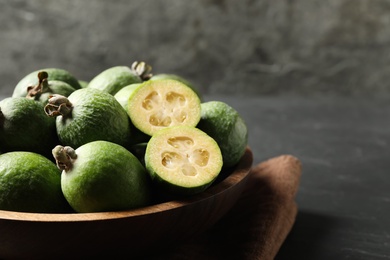 Delicious fresh feijoas on black table, closeup