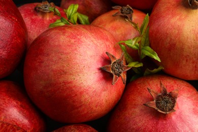 Photo of Many fresh ripe pomegranates as background, closeup