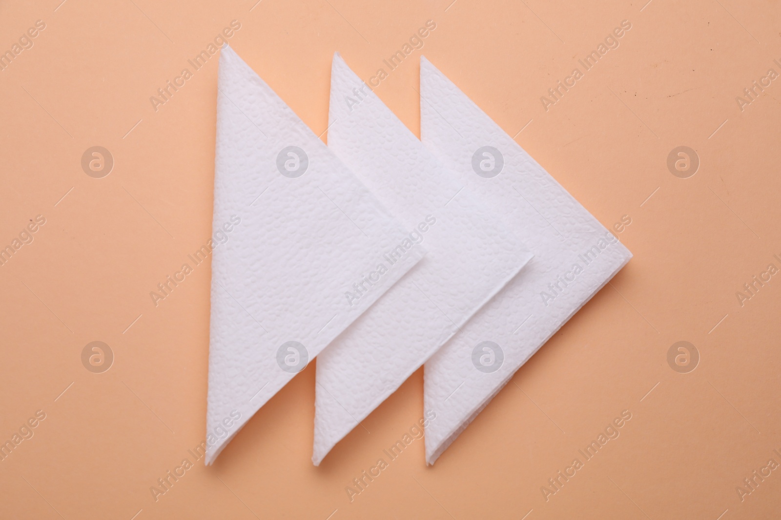 Photo of Clean paper tissues on beige background, top view