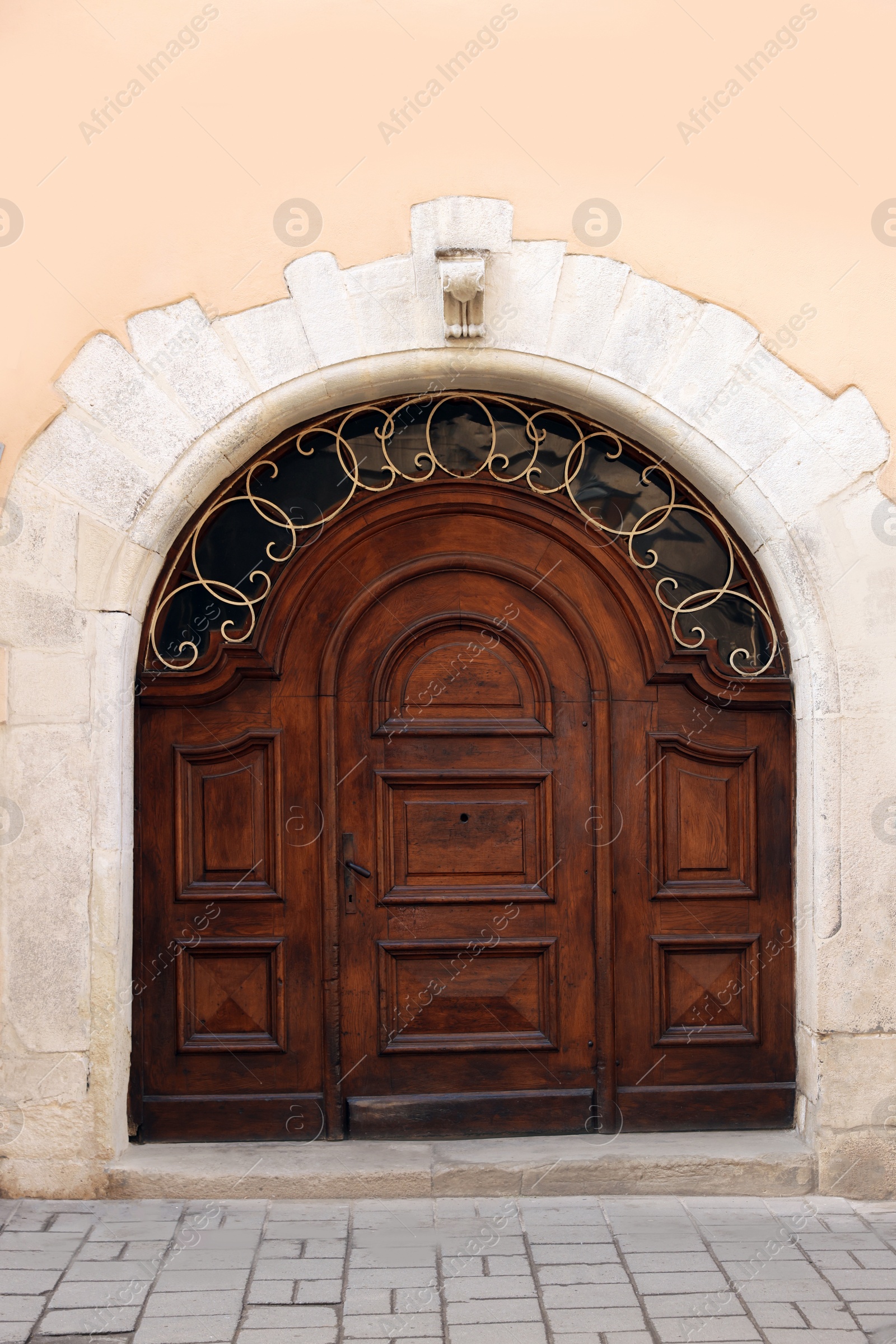 Photo of Entrance of house with beautiful arched wooden door