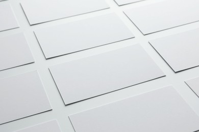 Blank business cards on white background, closeup. Mockup for design