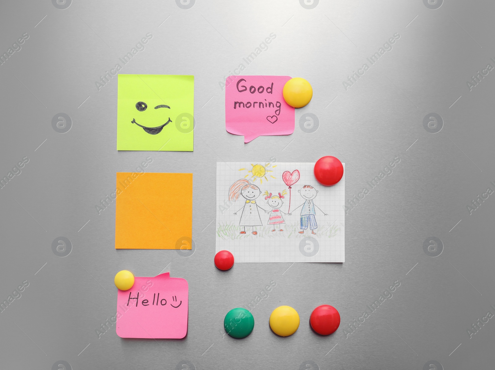 Photo of Paper sheets, child's drawing and magnets on refrigerator door