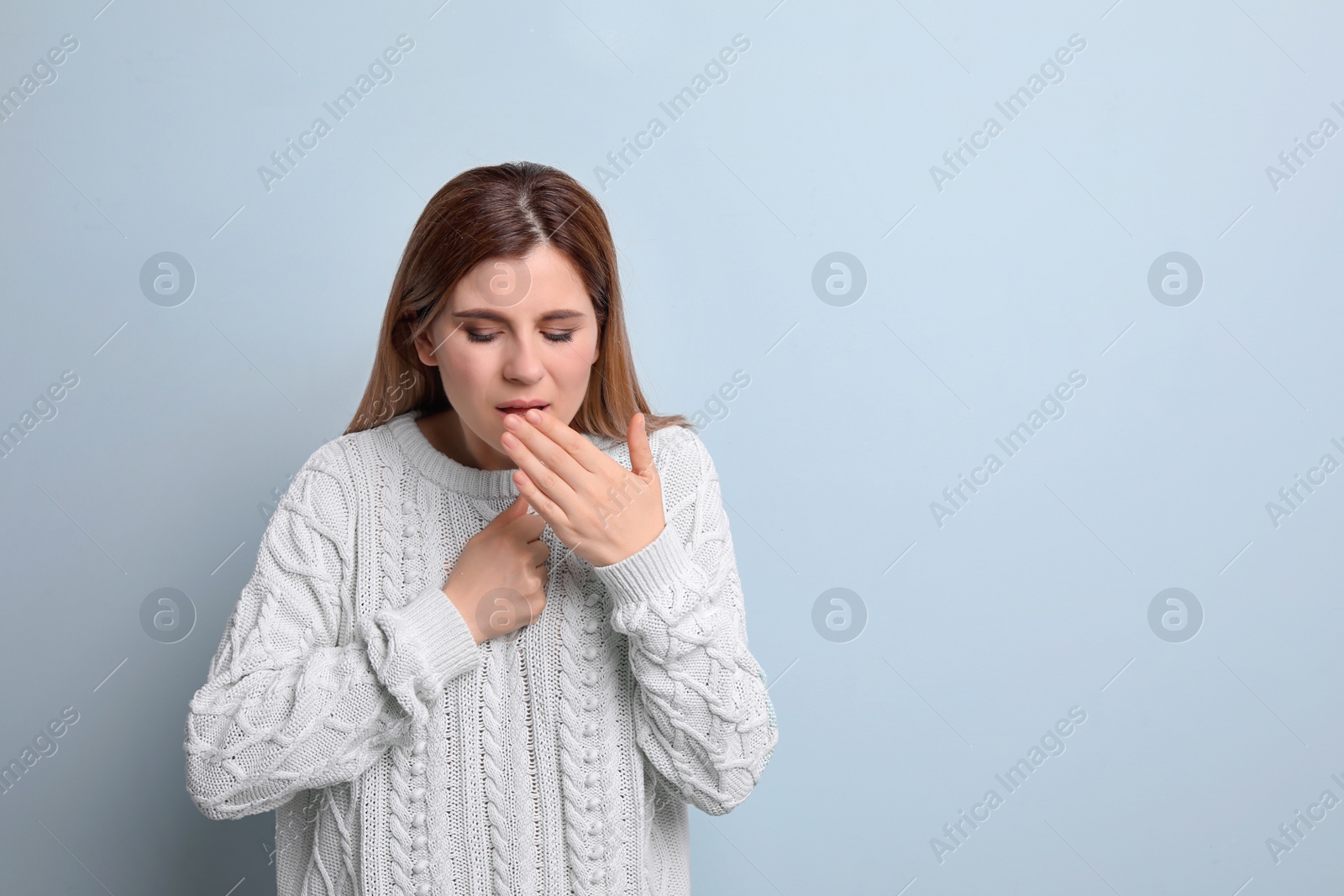 Photo of Woman coughing on color background