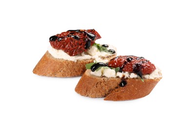 Photo of Delicious bruschettas with sun-dried tomatoes, cream cheese and balsamic vinegar isolated on white