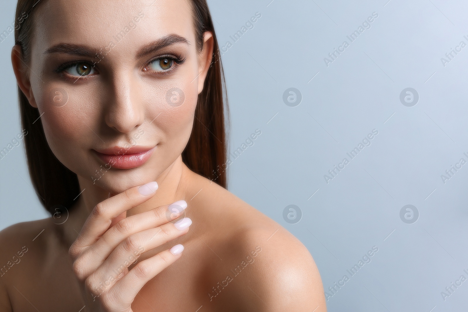 Photo of Portrait of beautiful young woman with plump lips on light grey background. Space for text