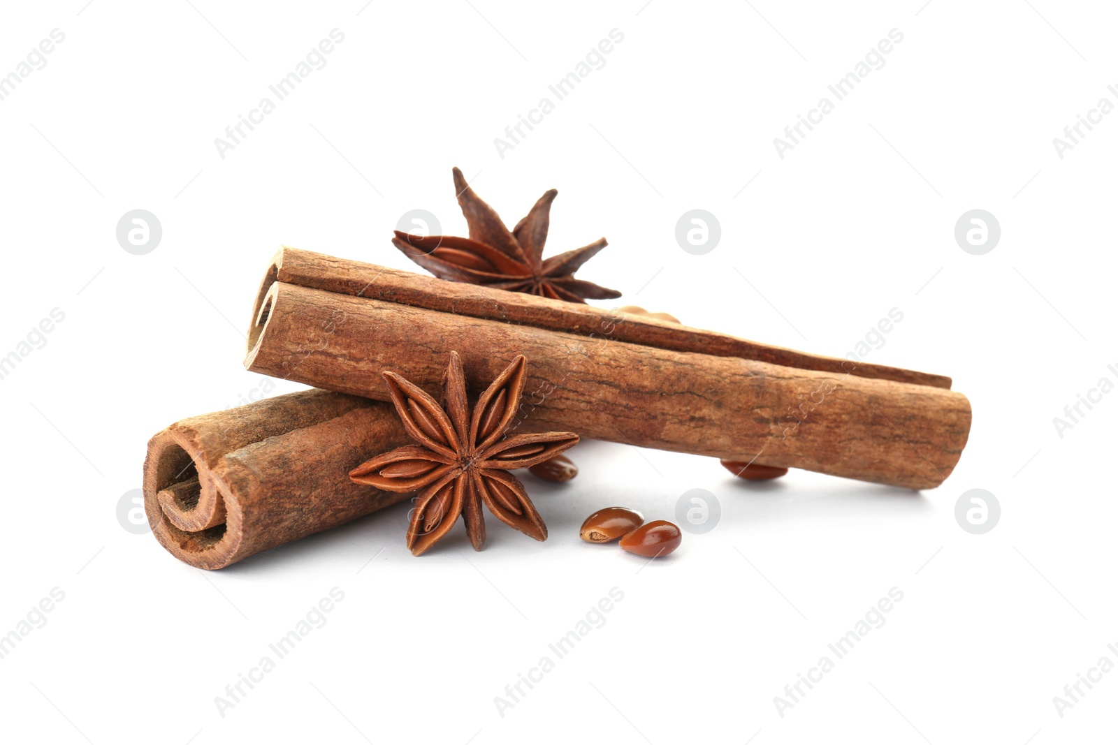 Photo of Aromatic cinnamon sticks and anise on white background