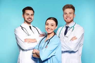 Photo of Group of medical doctors on color background. Unity concept