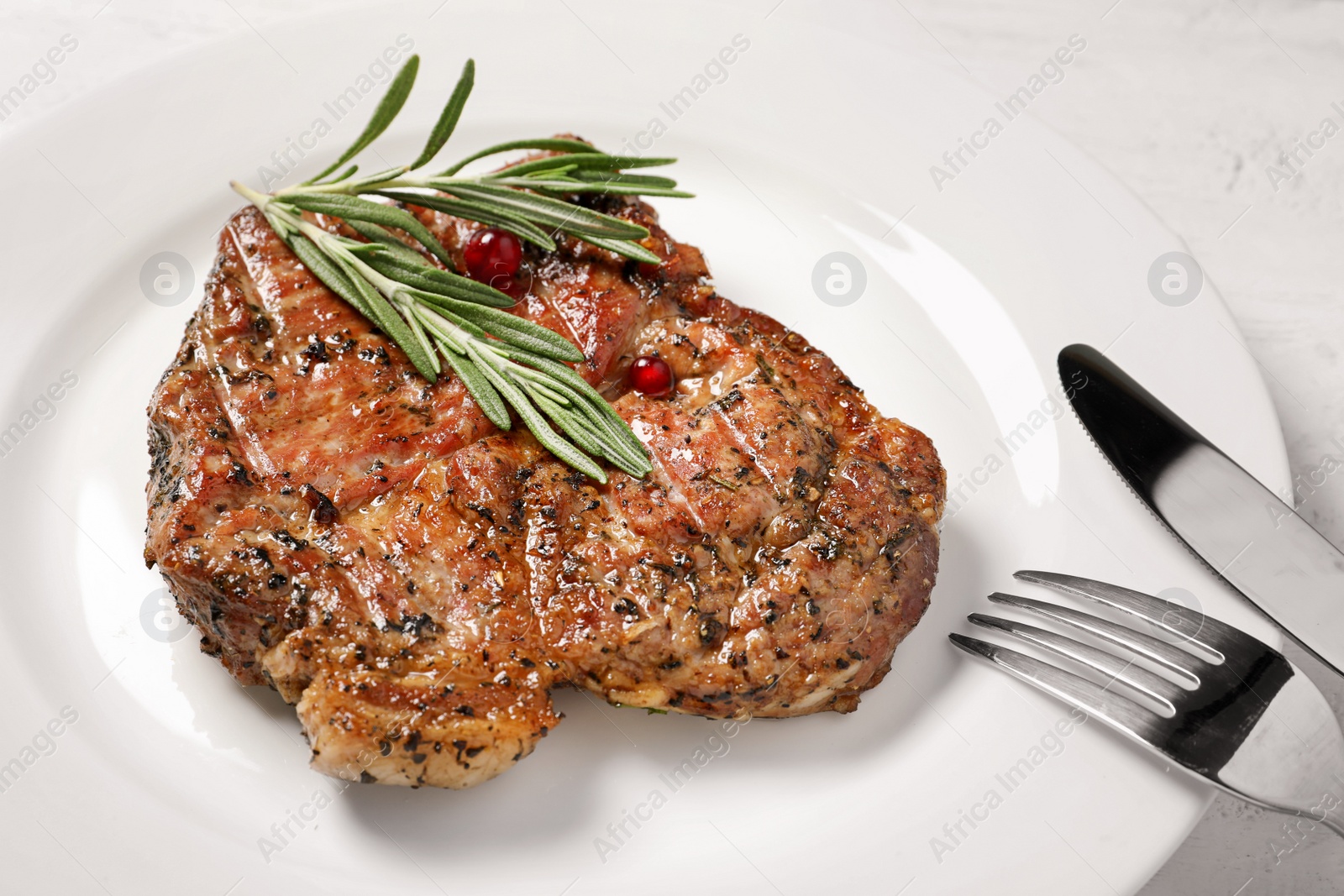 Photo of Plate with tasty grilled meat on table, closeup