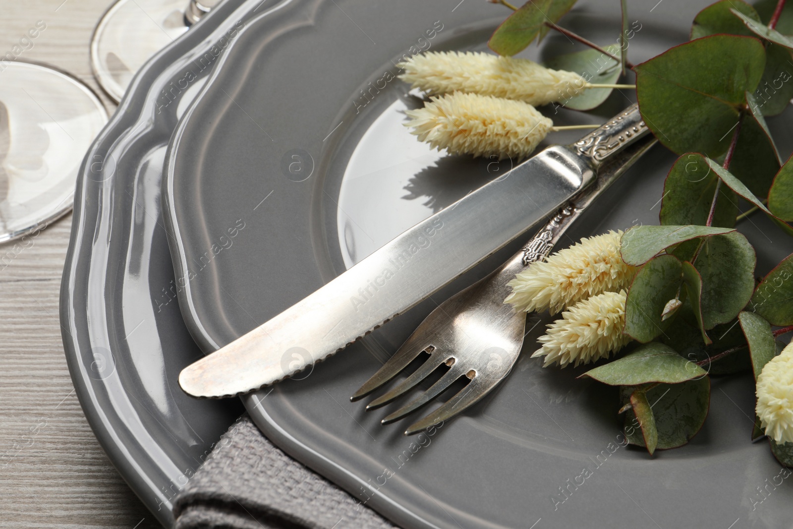 Photo of Festive table setting with autumn decor on wooden desk, closeup