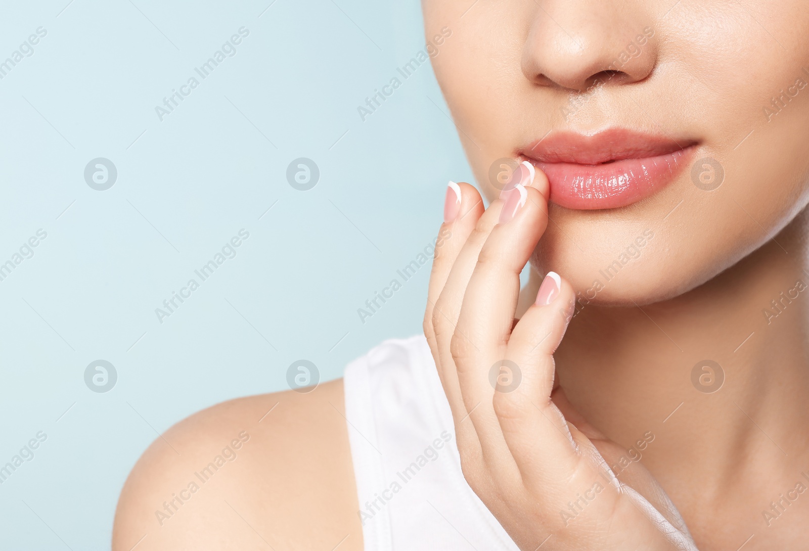 Photo of Young woman with sexy lips on color background, closeup