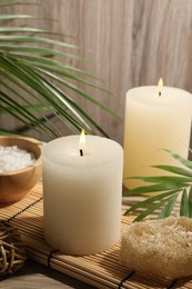 Composition with spa supplies and palm leaves on wooden table